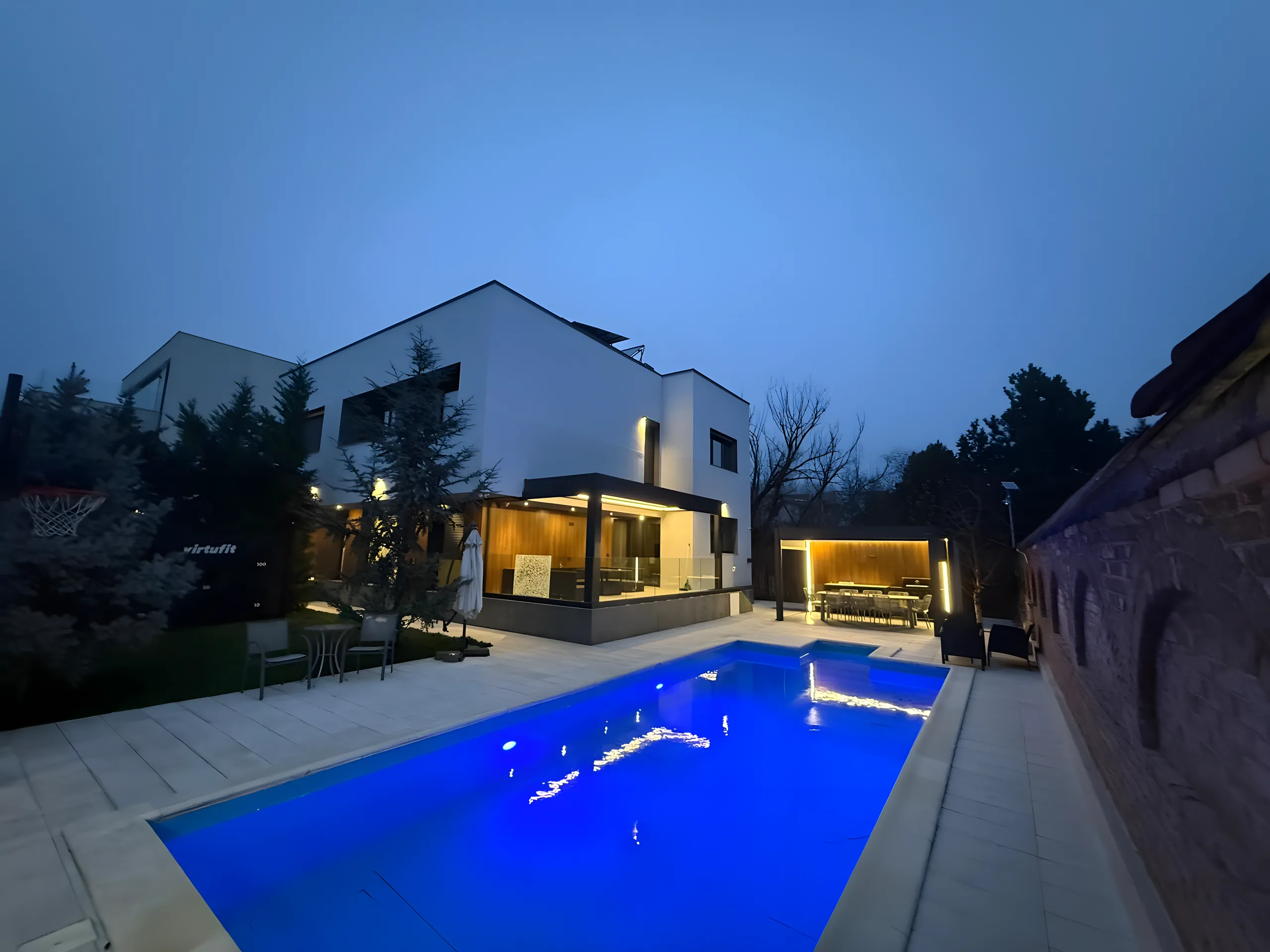 Vilă modernă la lăsarea serii, cu piscină și terasă acoperită închisă cu sticlă
